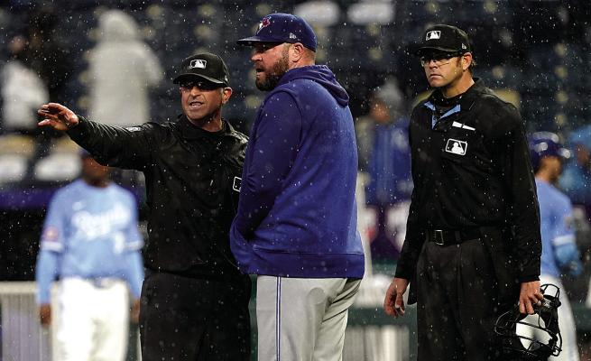 Manager John Schneider of the Toronto Blue Jays talks with crew chief Chris Guccione as rain falls in the fifth inning against the Kansas City Royals at Kauffman Stadium on Thursday, April 25, 2024, in Kansas City, Missouri. Ed Zurga | Getty Images | TNS