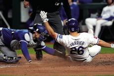 Adam Frazier (26) of the Kansas City Royals is tagged out by Danny Jansen (9) of the Toronto Blue Jays as he tries to score in the seventh inning at Kauffman Stadium on Monday, April 22, 2024, in Kansas City, Missouri. Ed Zurga | Getty Images | TNS