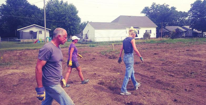 SCANNING THE GROUND — Gary Hogsett, Jodi Hayse and Anne Hogsett, left to right, scan the ground to make sure there were no unwanted items.